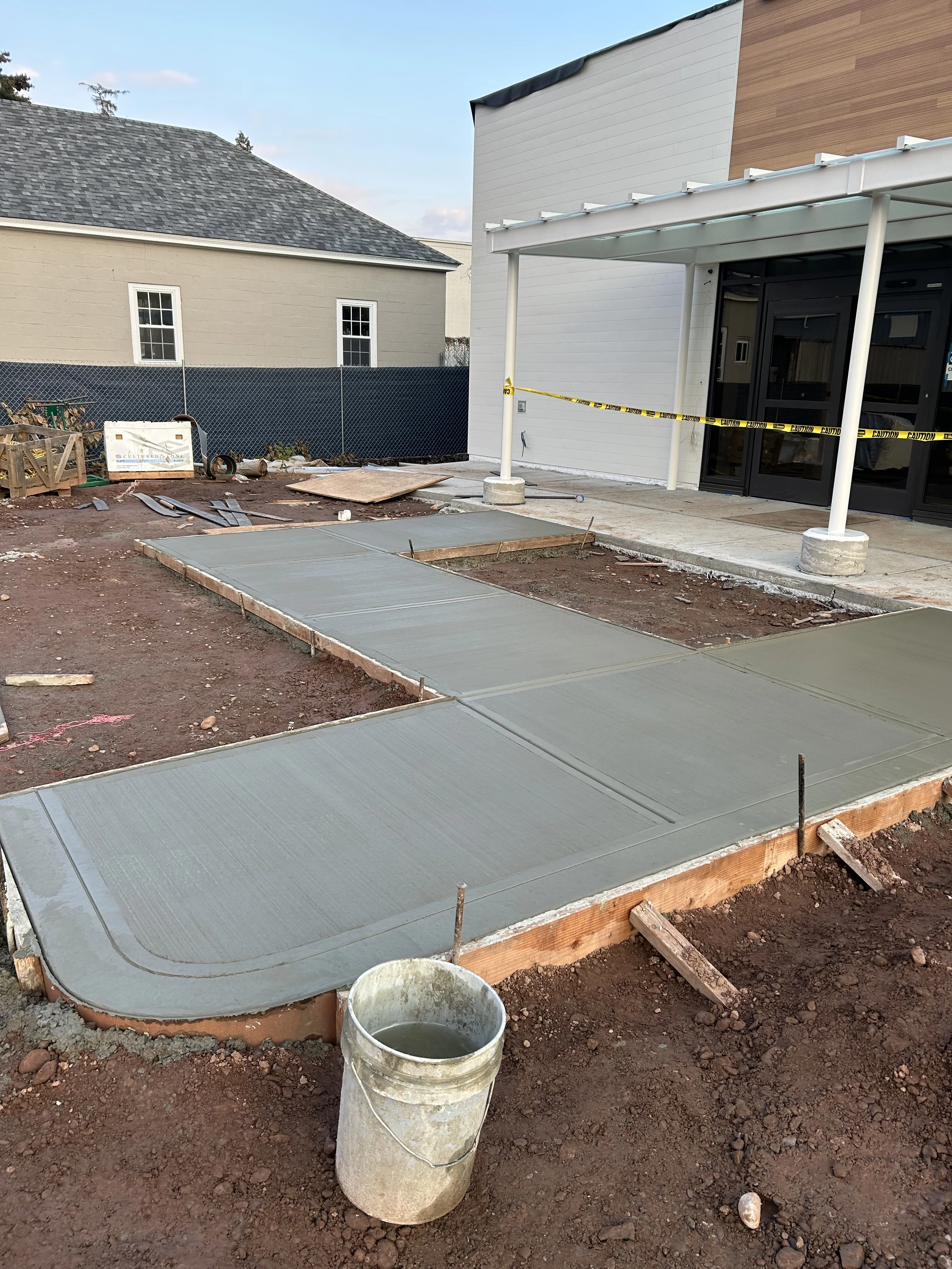 R Monarca Construction crew finishing concrete slab with pump truck on site